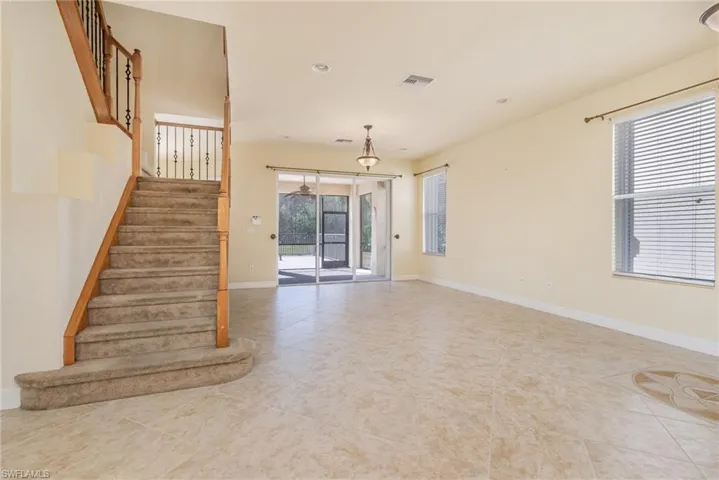 Living room with light tile patterned flooring.