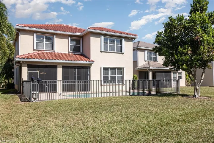Back of property with a fenced in pool, a yard, and a patio area.