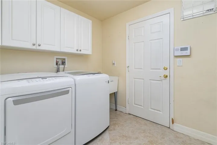 Laundry room featuring  white cabinets, washer and dryers (included).