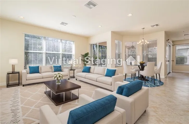 Virtual Staged Photo - Living room featuring baseboards, a notable chandelier, and visible vents
