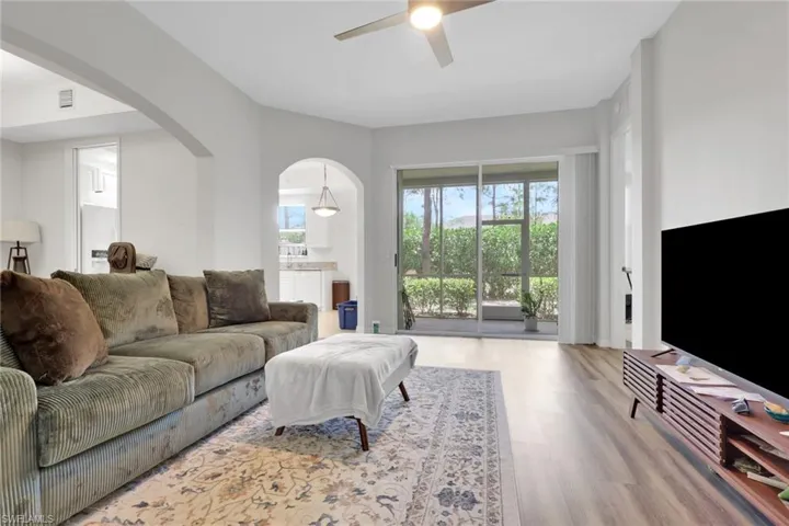 Open living area featuring wood-finish flooring and a ceiling fan