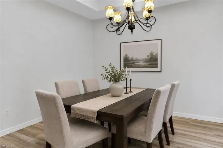Dining area featuring a dark wood-finish dining table and wood-finish flooring
