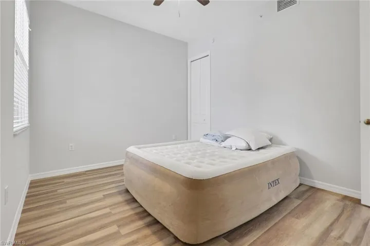 Interior room featuring wood-finish flooring and light gray walls