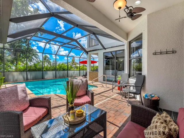 View of pool featuring outdoor lounge area, ceiling fan, a lanai, and a patio