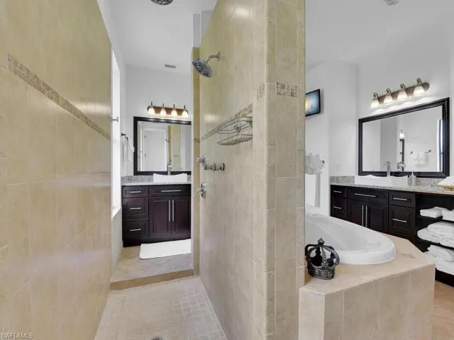 Bathroom featuring tile patterned flooring, vanity, and independent shower and bath