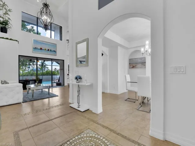 Entryway with a notable chandelier and light tile patterned flooring