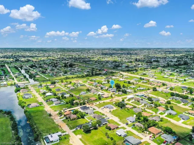 Birds eye view of property with a water view