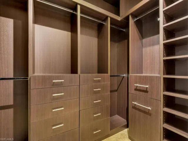 Spacious closet with light tile patterned floors