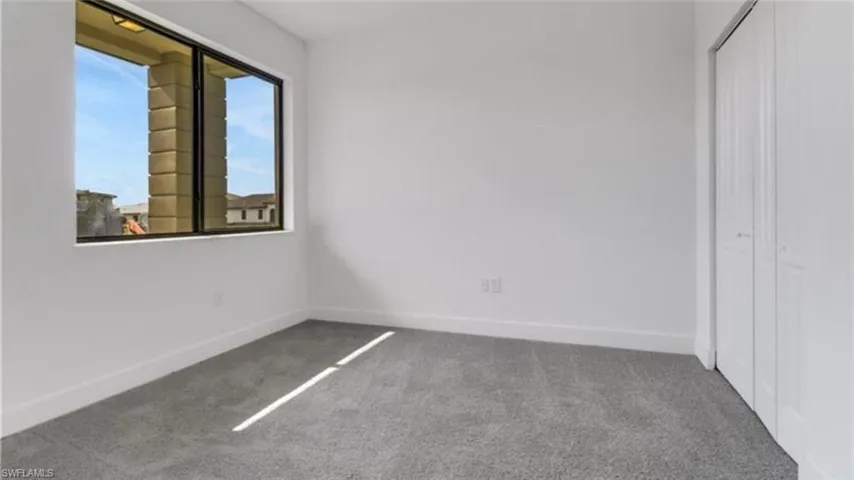 Unfurnished bedroom with carpet flooring and a closet