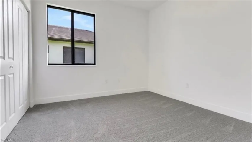 Unfurnished bedroom featuring carpet and a closet