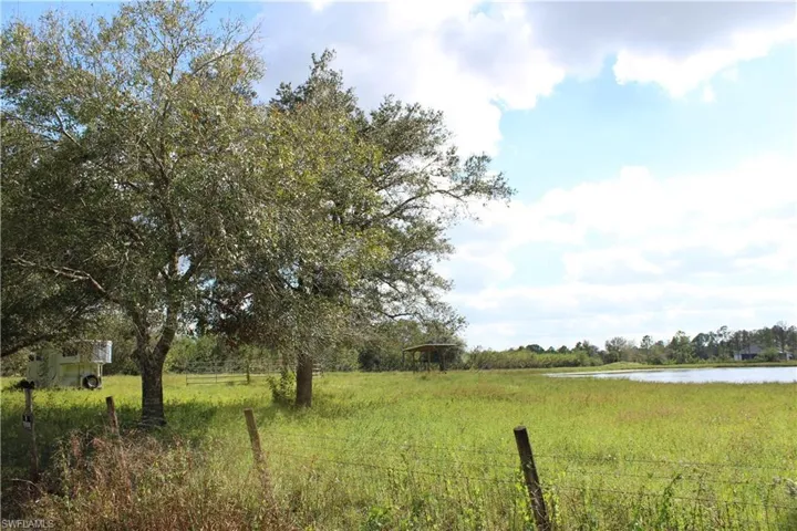 View of yard featuring a rural view and a water view