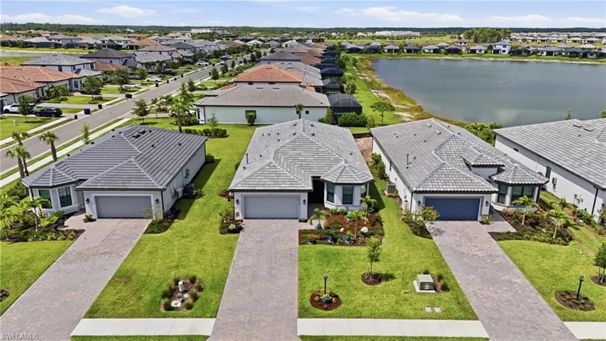 Contemporary single-story residence featuring a gray tile roof and a paver driveway