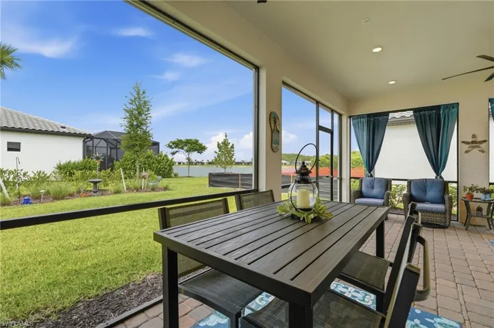 Screened lanai featuring paver flooring, recessed lighting, and a ceiling fan