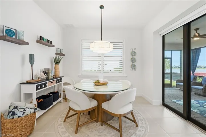 Dining area with light tile flooring and white walls