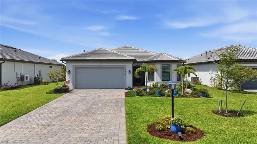 Contemporary single-story residence with a gray tile roof and white stucco exterior