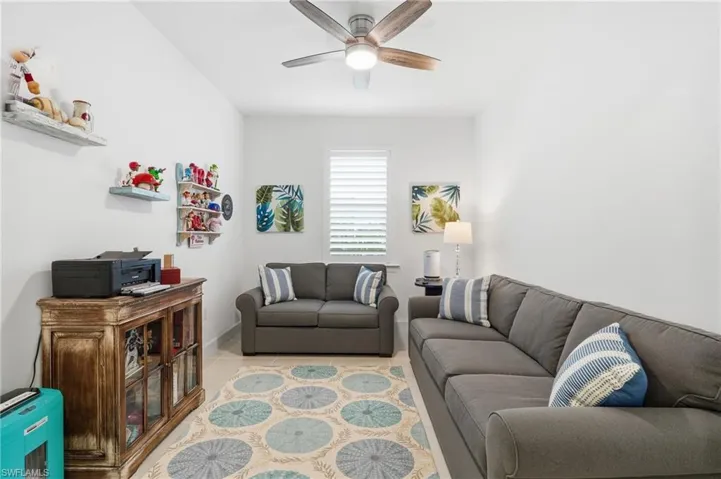 Bright room with white walls, recessed lighting, and a ceiling fan