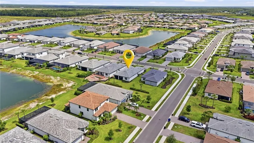 Aerial perspective of a developed residential community with multiple single-story residences