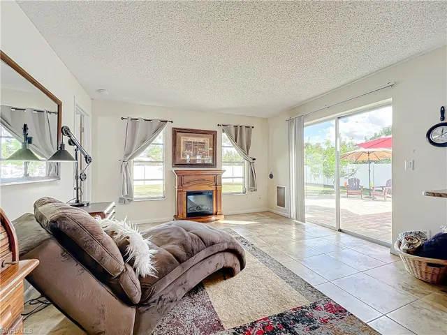 Tiled living room with a textured ceiling