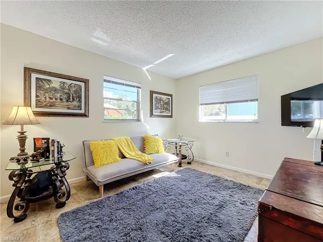 Living room featuring plenty of natural light and a textured ceiling