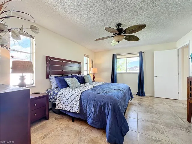 Bedroom featuring a textured ceiling and ceiling fan