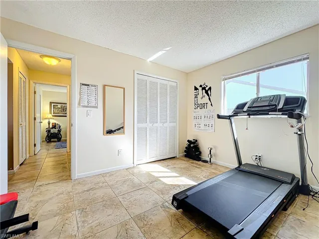 Workout room with a textured ceiling