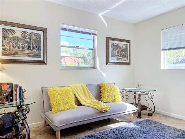 Sitting room featuring tile patterned flooring, plenty of natural light, and a textured ceiling