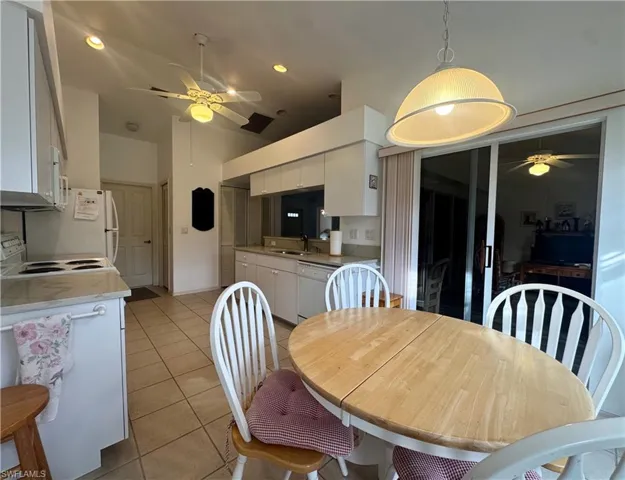 Dining area featuring a ceiling fan, light tile patterned flooring, and recessed lighting