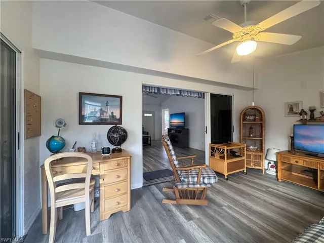 Office space with wood finished floors and a ceiling fan