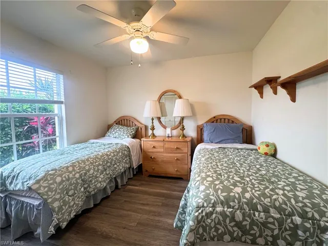 Bedroom with dark wood-style floors and ceiling fan