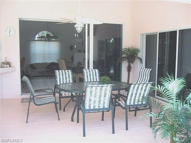 View of patio with ceiling fan and outdoor dining space