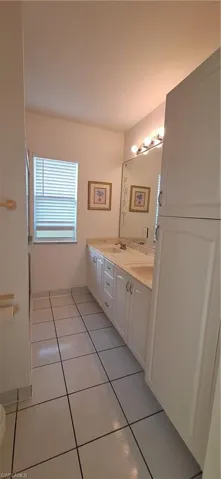 Bathroom featuring tile patterned floors and double vanity