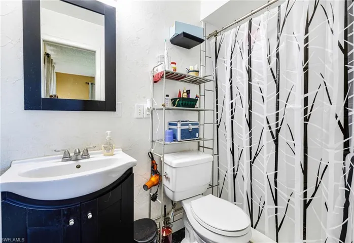 Bathroom featuring vanity, toilet, and walk in shower