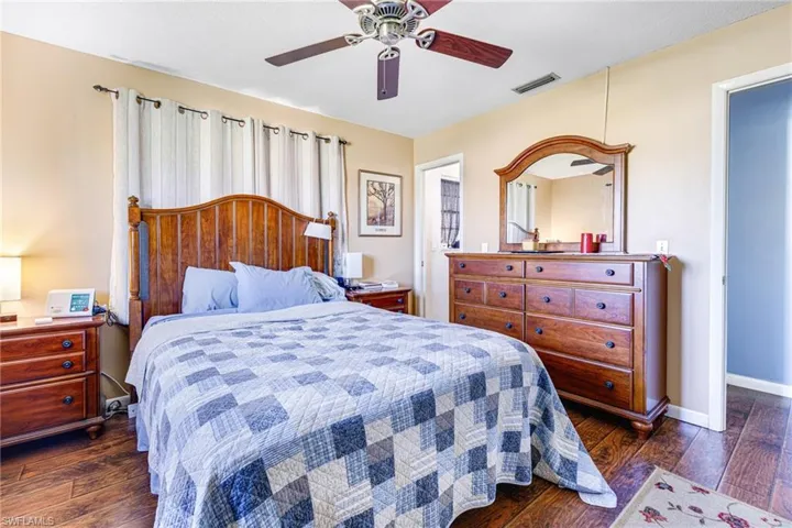Bedroom featuring ceiling fan and dark wood-type flooring