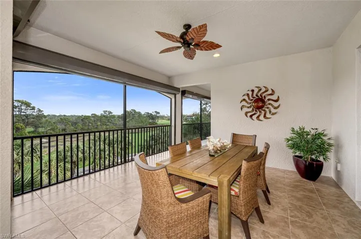Sunroom / solarium featuring ceiling fan
