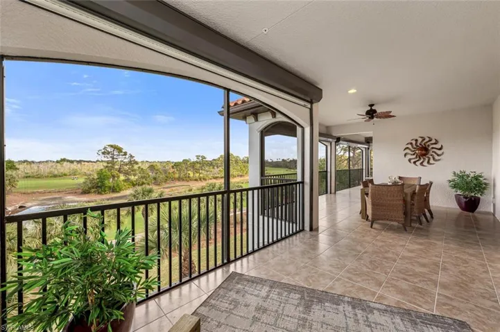 View of patio with a balcony and ceiling fan