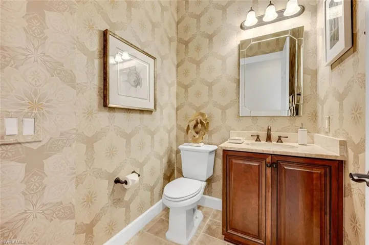 Bathroom with vanity, tile patterned floors, and toilet