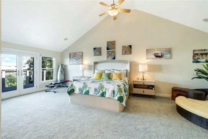 Large Primary Bedroom with French doors to a balcony overlooking the waterway,