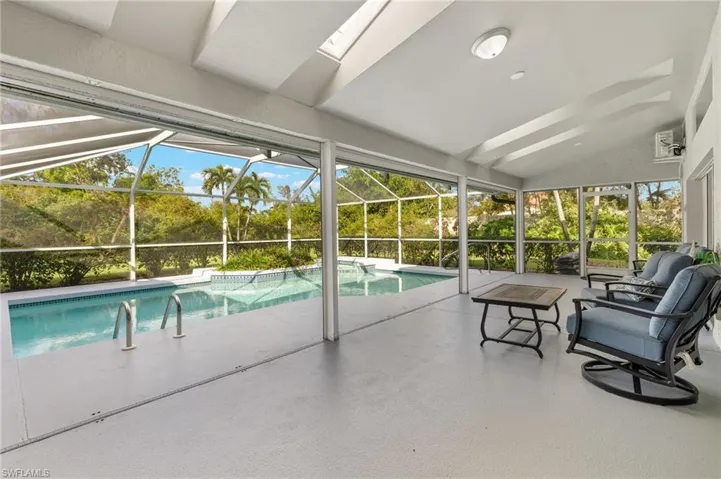 View of pool with a patio area and a lanai