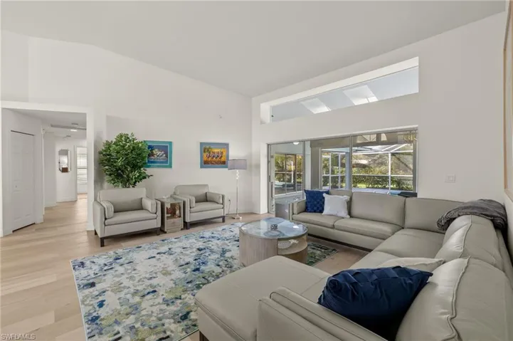 Living room featuring vaulted ceiling and light wood-type flooring