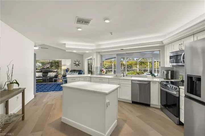 Kitchen featuring white cabinetry, light hardwood / wood-style floors, and stainless steel appliances