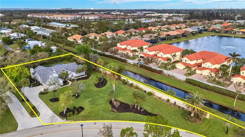 Birds eye view of property with a water view