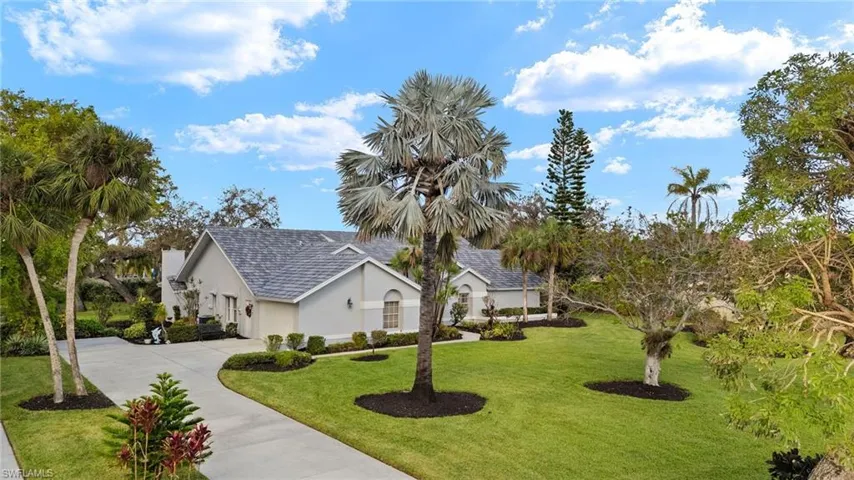 View of side of home with a yard