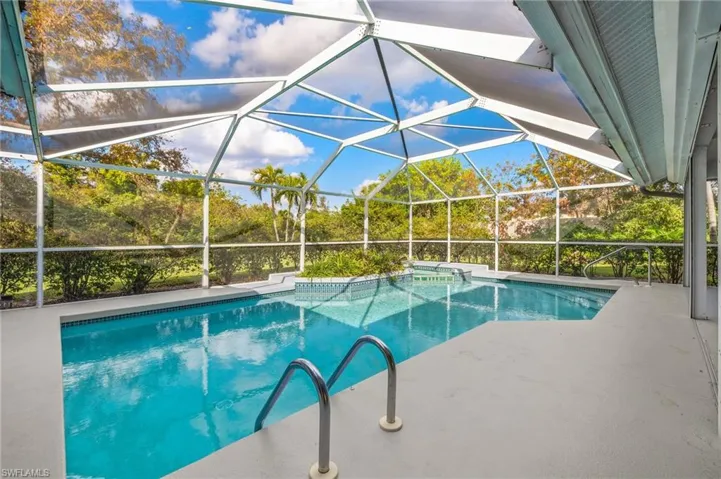 View of swimming pool with a patio area and a lanai