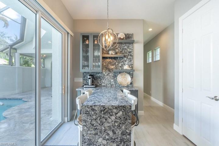 Custom built granite tasting counter with wine fridge built in