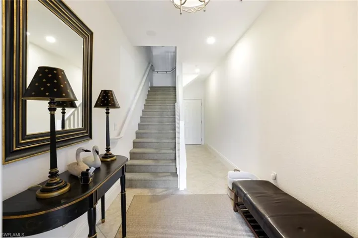 Staircase featuring recessed lighting and tile patterned floors