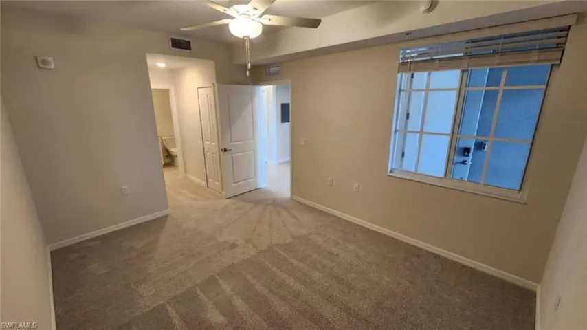 Carpeted room with a ceiling fan, recessed lighting, and a window with blinds