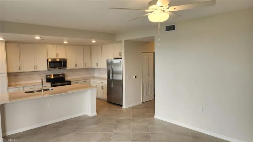 Modern kitchen featuring light cabinetry, stainless steel appliances, and a subway tile backsplash