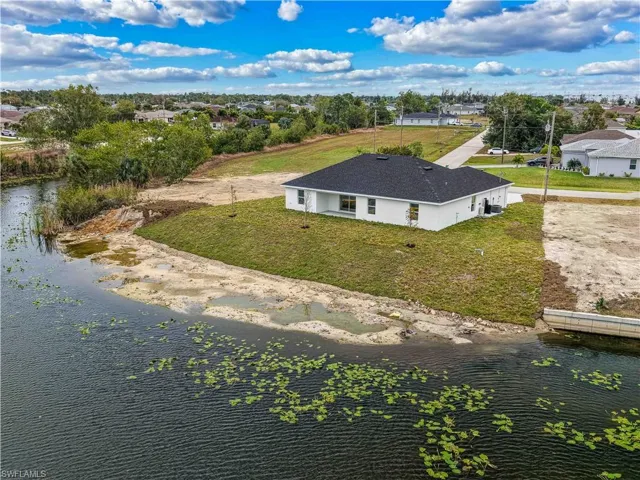 Aerial perspective of suburban area with a large body of water