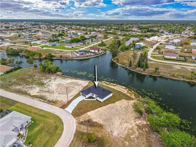 Aerial perspective of suburban area with a large body of water