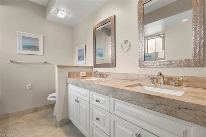 Bathroom with vanity, toilet, and tile patterned floors
